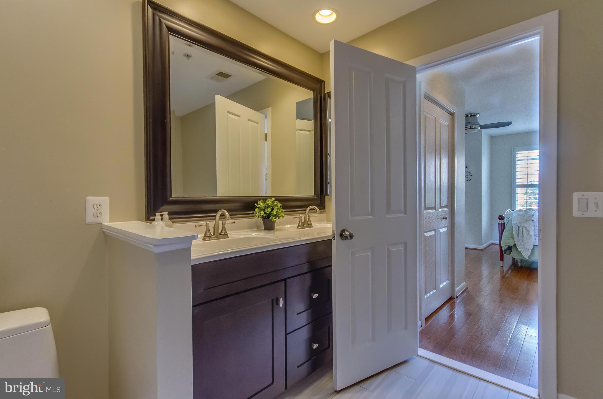 2116 12th Street Northwest Washington, DC 20009 - Photo 17 of 30 a bathroom with a granite countertop sink shower and a mirror