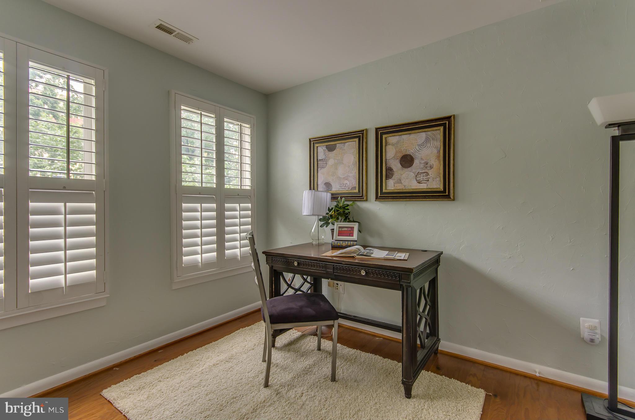 2116 12th Street Northwest Washington, DC 20009 - Photo 3 of 30 a view of a workspace with furniture and a window