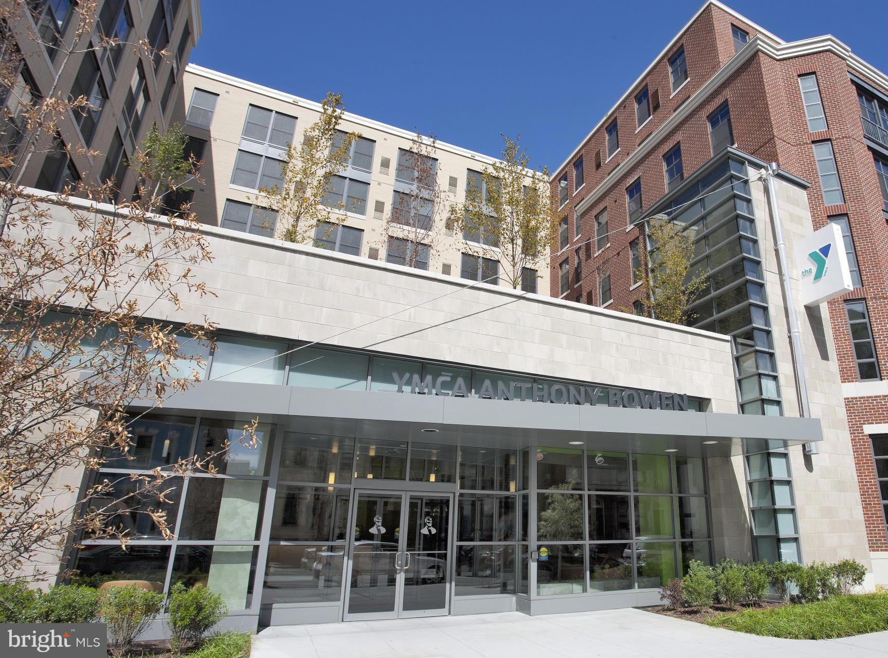 2116 12th Street Northwest Washington, DC 20009 - Photo 28 of 30 a front view of a building with glass windows and plants