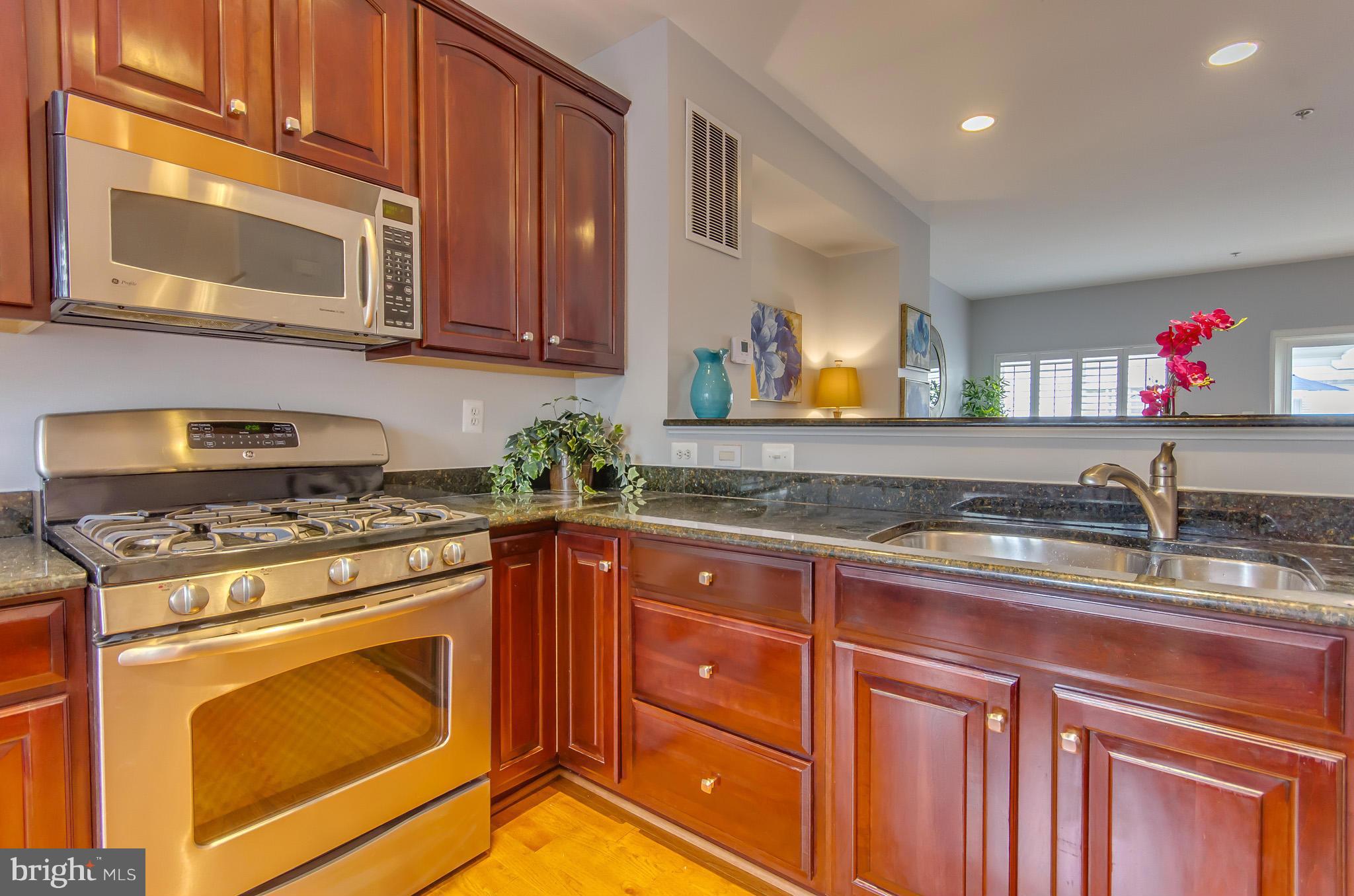2116 12th Street Northwest Washington, DC 20009 - Photo 10 of 30 a kitchen with stainless steel appliances granite countertop a stove and a sink