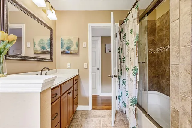 a view of a hallway with wooden floor with windows