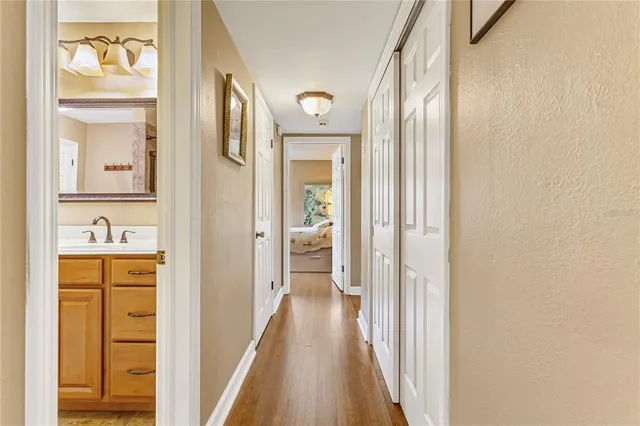 a spacious bedroom with a bed and a flat screen tv