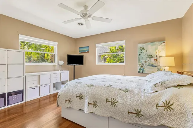 a spacious bedroom with a bed and a chandelier