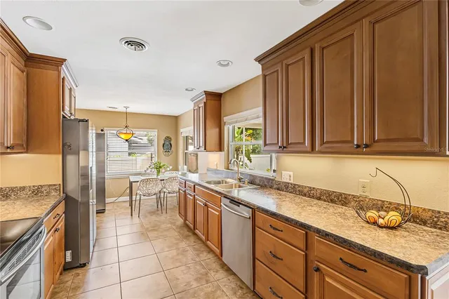 a kitchen with stainless steel appliances granite countertop a stove and a sink
