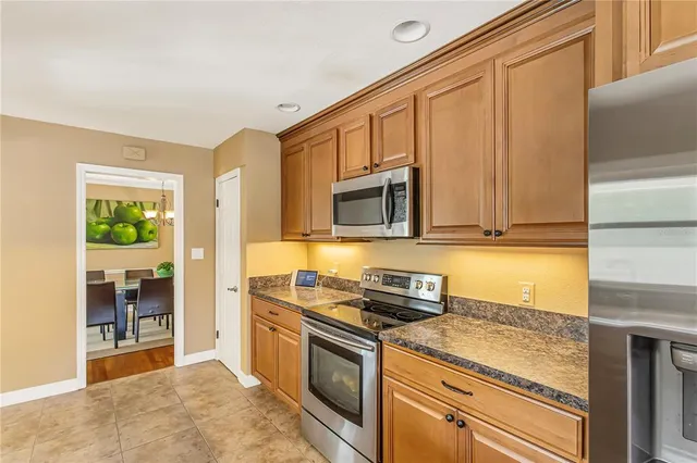 a bathroom with a granite countertop sink and a window