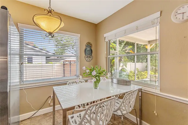 a view of a patio with table and chairs and potted plants