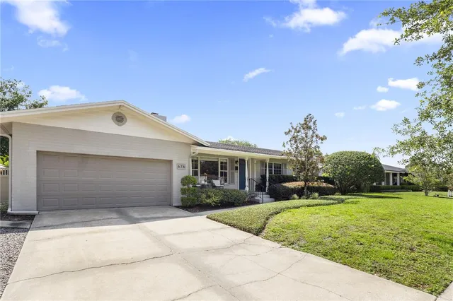 an aerial view of residential houses with outdoor space and river