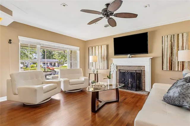 a living room with fireplace furniture and a flat screen tv