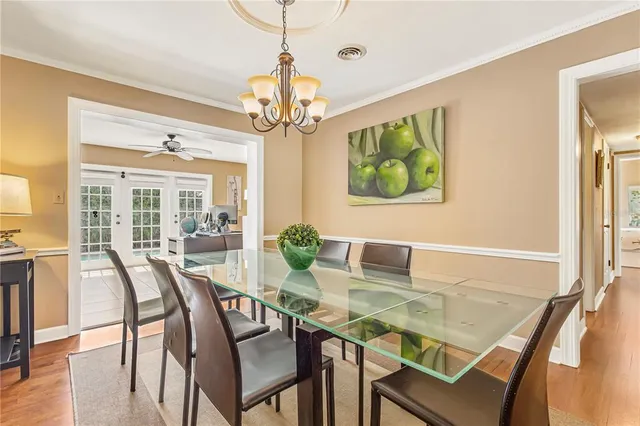 a view of a dining room with furniture a livingroom and chandelier