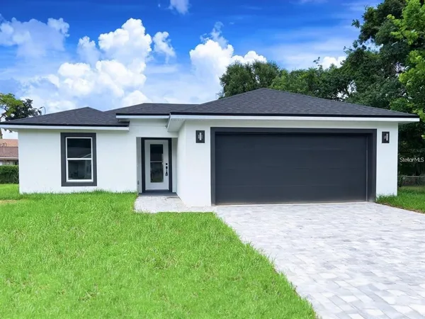 a front view of house with yard and green space