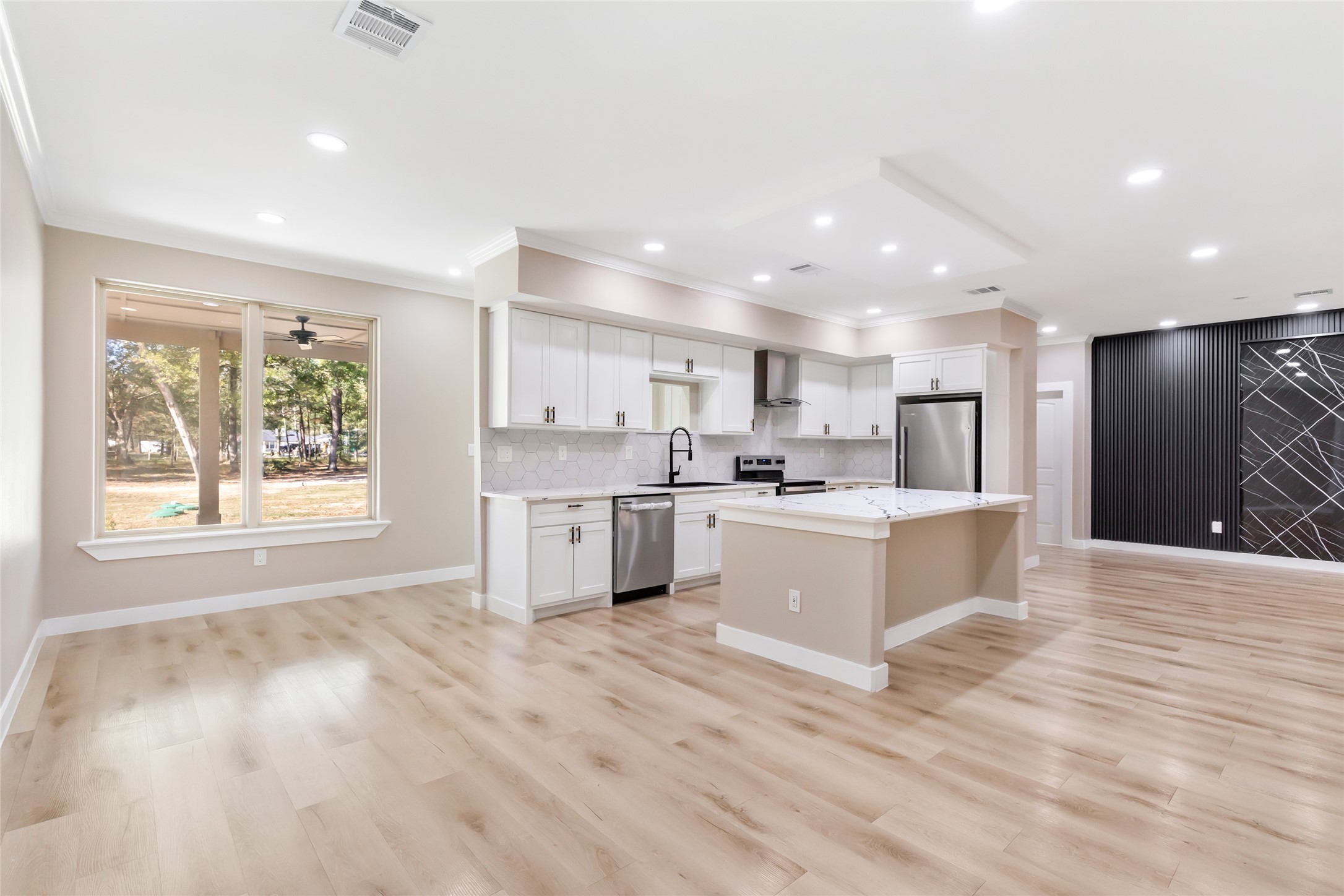 26707 Apache Trail Magnolia, TX 77354 - Photo 18 of 37 a large white kitchen with a large window and white stainless steel appliances