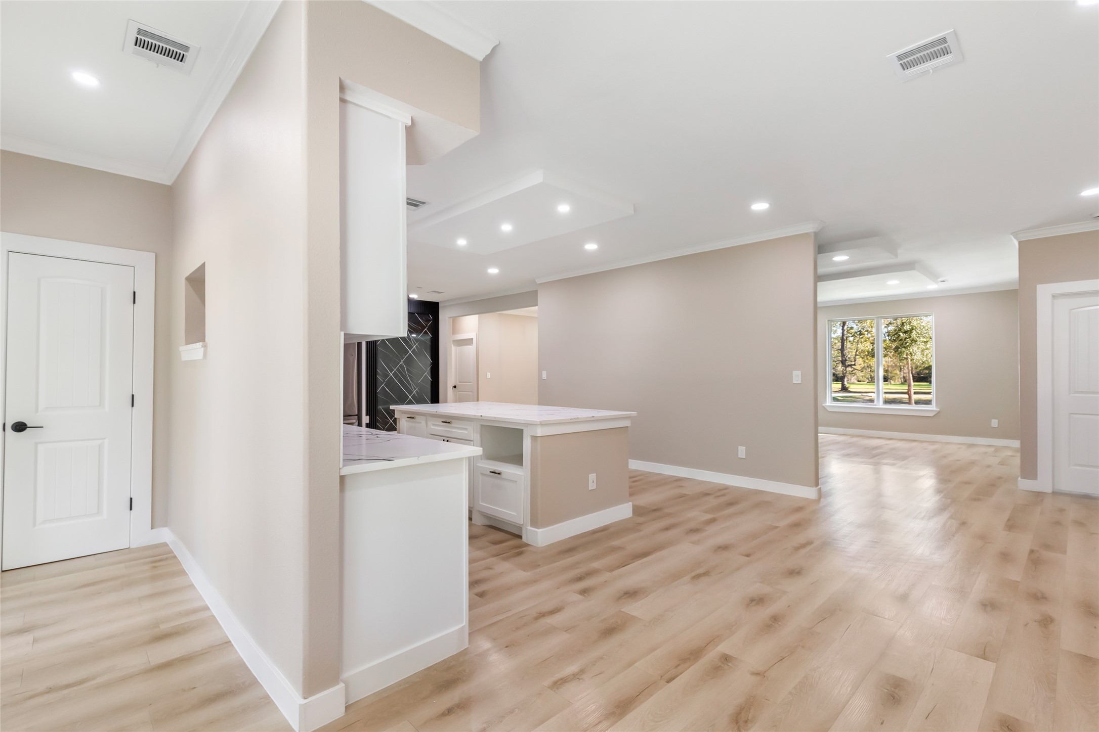 26707 Apache Trail Magnolia, TX 77354 - Photo 19 of 37 an empty room with wooden floor and a kitchen
