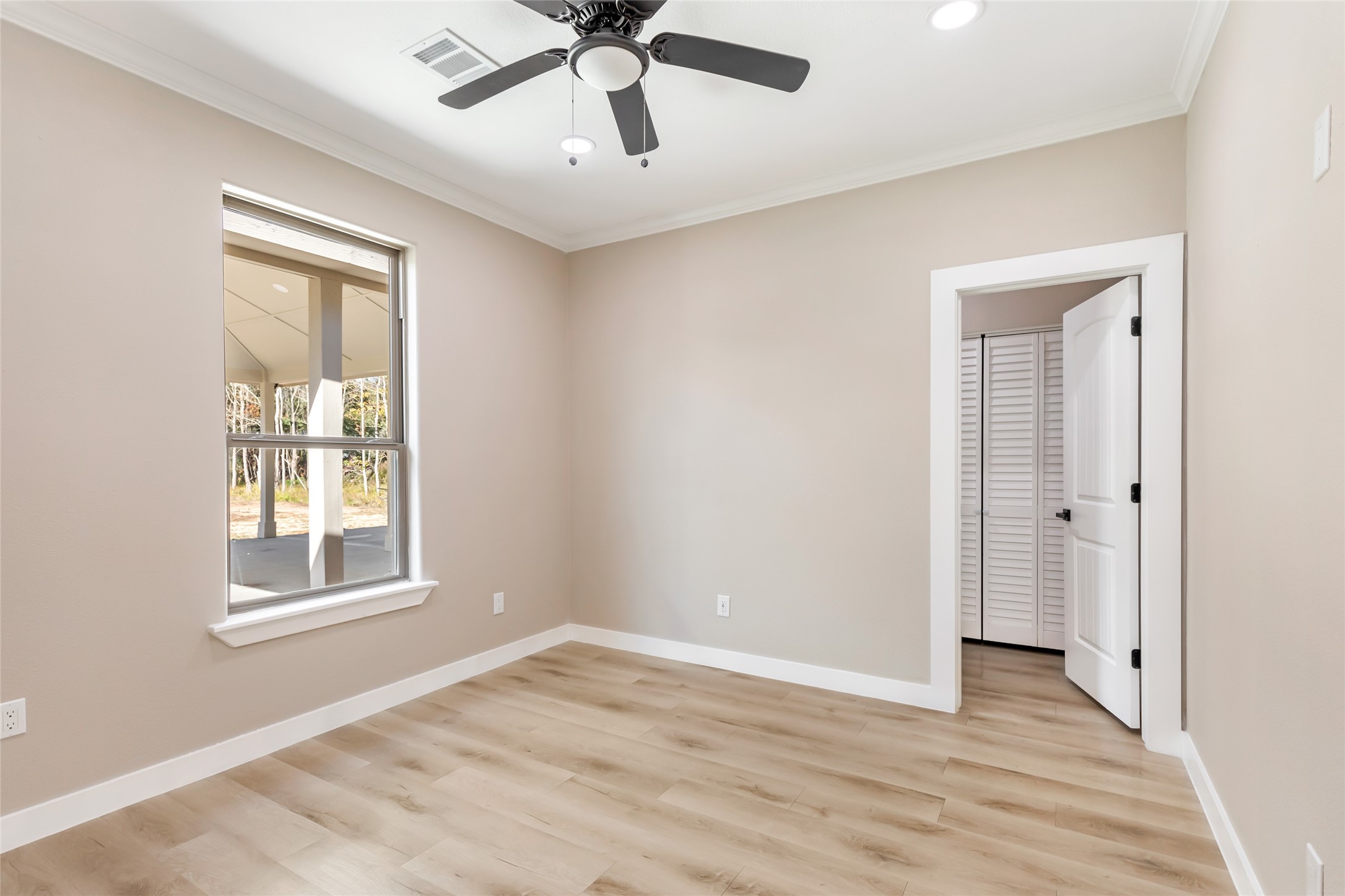 26707 Apache Trail Magnolia, TX 77354 - Photo 29 of 37 a view of an empty room with wooden floor and a window
