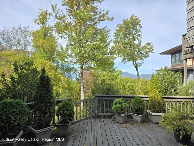a view of balcony with wooden floor and outdoor seating