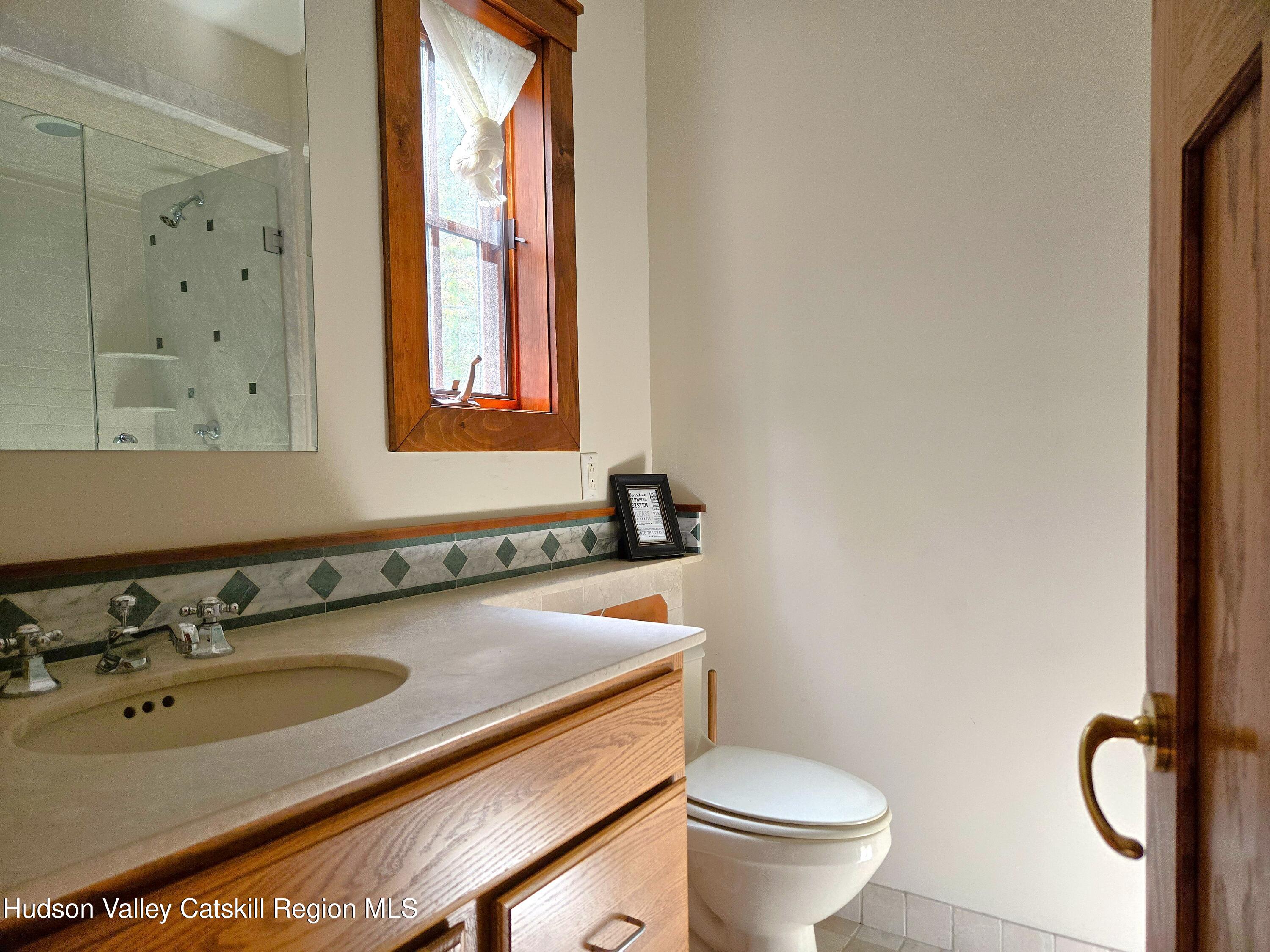 84 Highland Road Stone Ridge, NY 12484 - Photo 8 of 20 a bathroom with a toilet sink and mirror