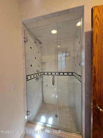 a bathroom with a glass shower door