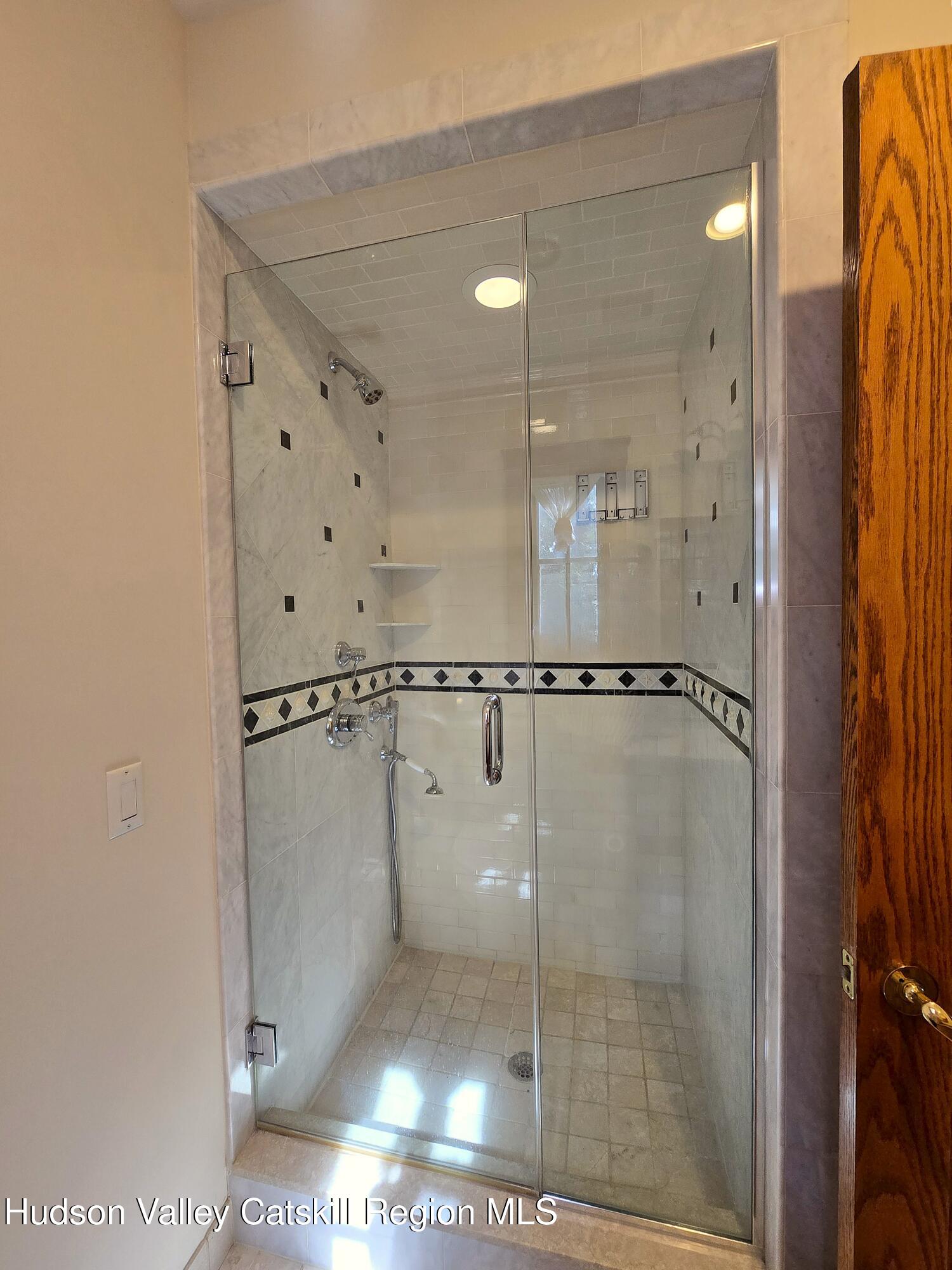 84 Highland Road Stone Ridge, NY 12484 - Photo 9 of 20 a bathroom with a glass shower door