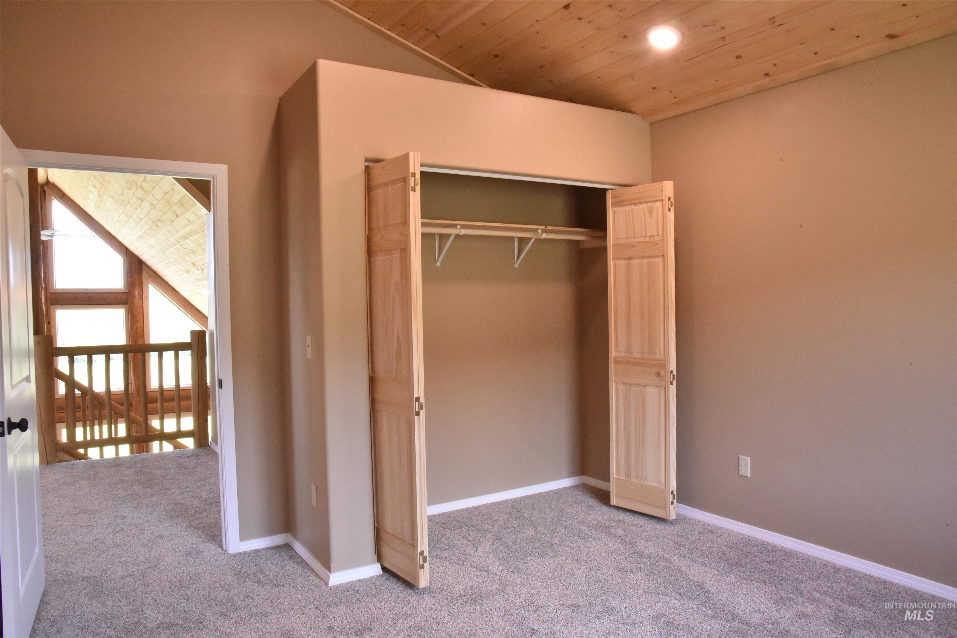 293 Vine Maple Desmet, ID 83824 - Photo 16 of 23 Unfurnished bedroom with carpet, wooden ceiling, recessed lighting, and a closet