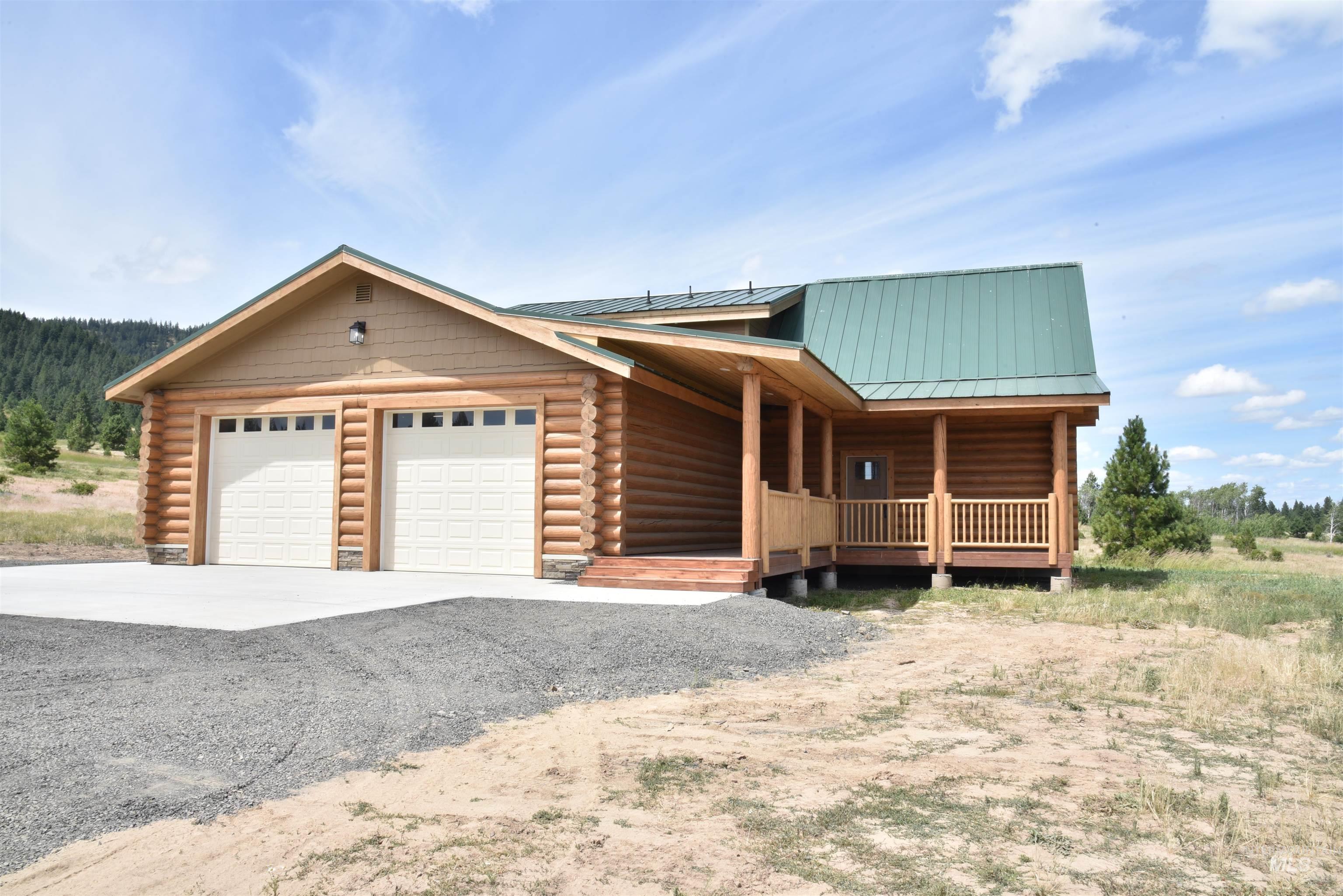 293 Vine Maple Desmet, ID 83824 - Photo 6 of 23 Log home with log siding, an attached garage, and driveway