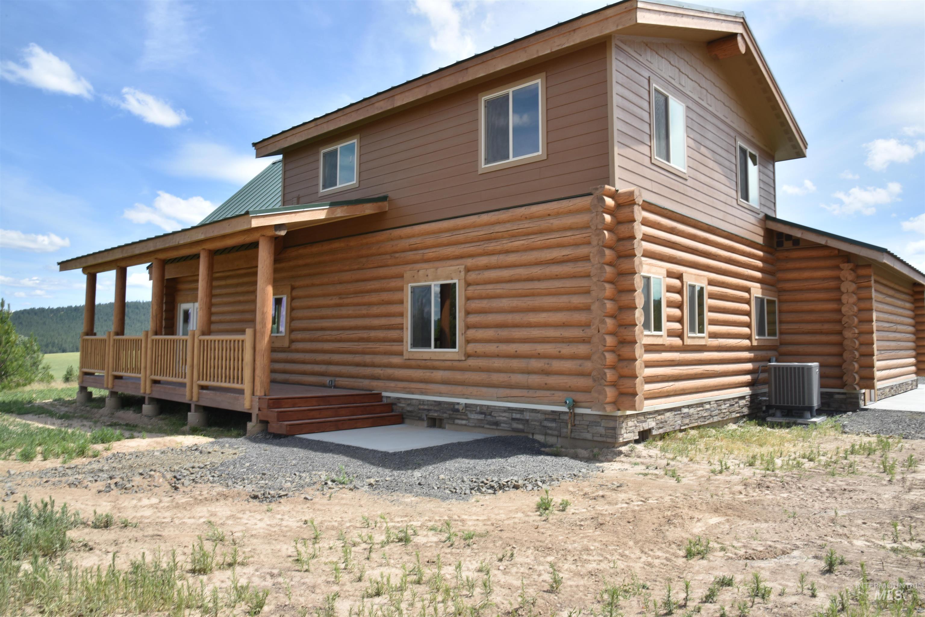 293 Vine Maple Desmet, ID 83824 - Photo 7 of 23 Back of house with log exterior and a porch
