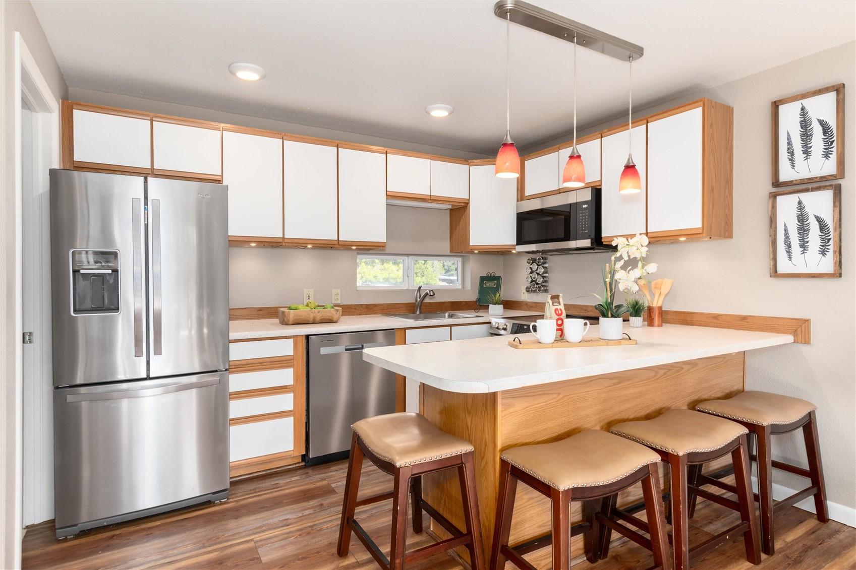163 High Tor Road, Unit 7 Breckenridge, CO 80424 - Photo 8 of 42 a kitchen with stainless steel appliances granite countertop a refrigerator a sink a stove a dining table and chairs with wooden floor
