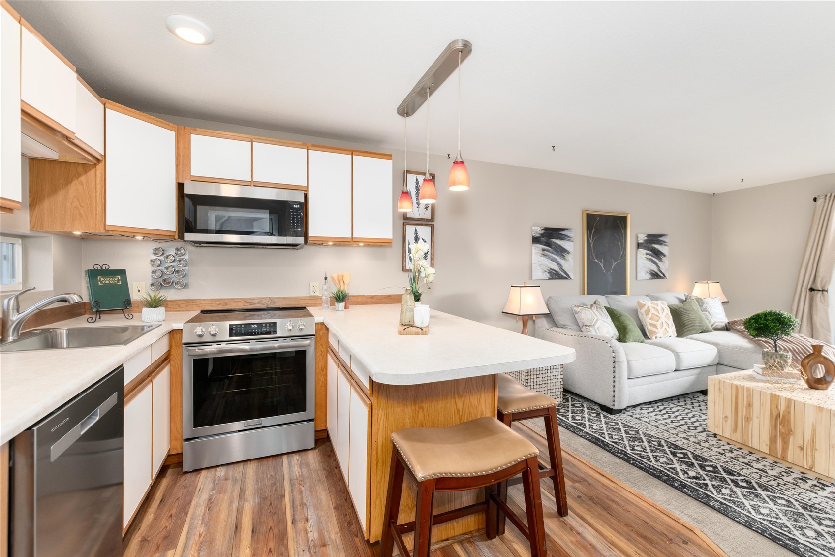 163 High Tor Road, Unit 7 Breckenridge, CO 80424 - Photo 9 of 42 a kitchen with stainless steel appliances granite countertop a stove top oven a sink dishwasher a dining table and chairs with wooden floor