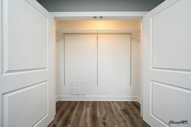 a view of a small space with wooden floor and a window
