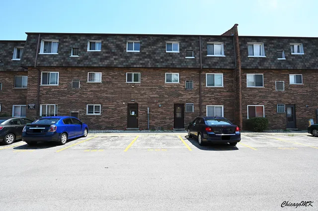 a car parked in front of a brick building