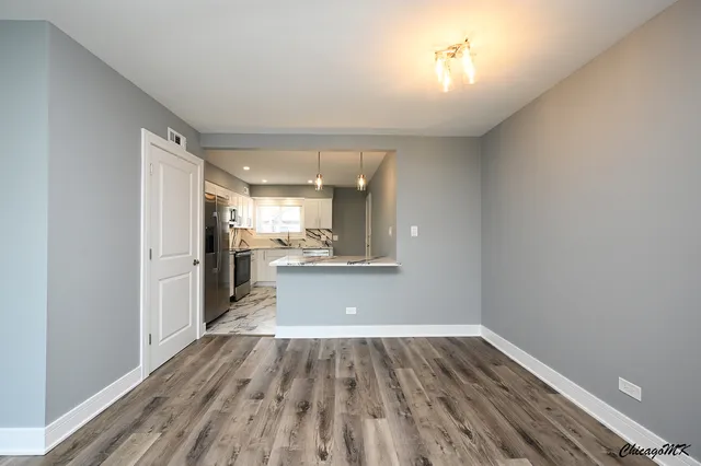 a view of a kitchen cabinets a counter top space and stainless steel appliances