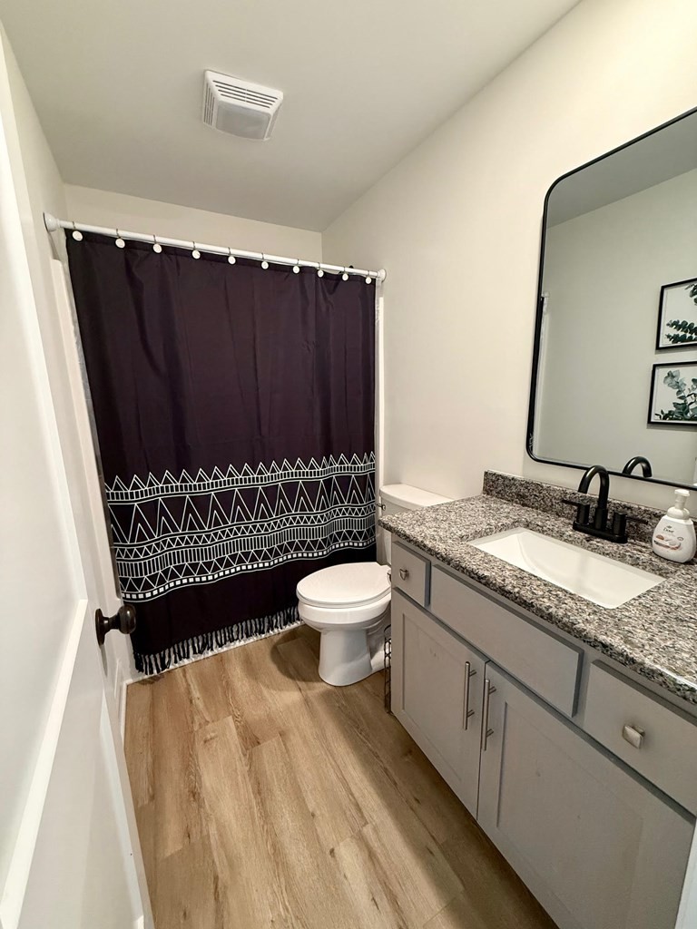 2617 Spring Arbor Court Cookeville, TN 38501 - Photo 17 of 32 a bathroom with a granite countertop toilet sink and mirror
