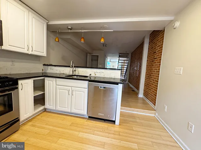 a kitchen with stainless steel appliances granite countertop a stove and a sink