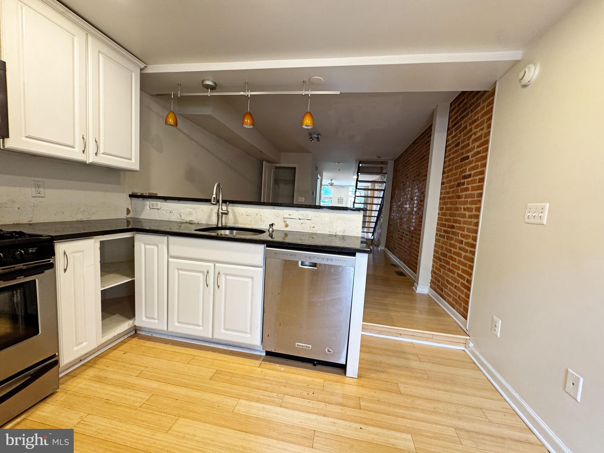 118 West Randall Street Baltimore, MD 21230 - Photo 11 of 22 a kitchen with stainless steel appliances granite countertop a stove and a sink