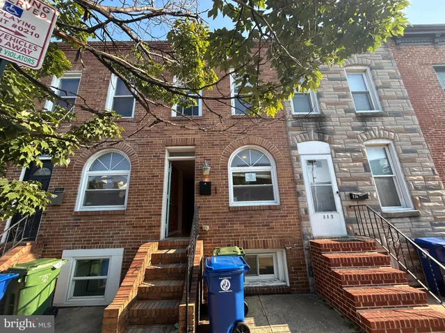 front view of a brick house with a large window
