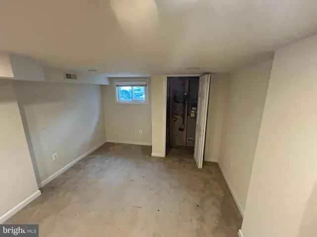 a view of an empty room with wooden walls