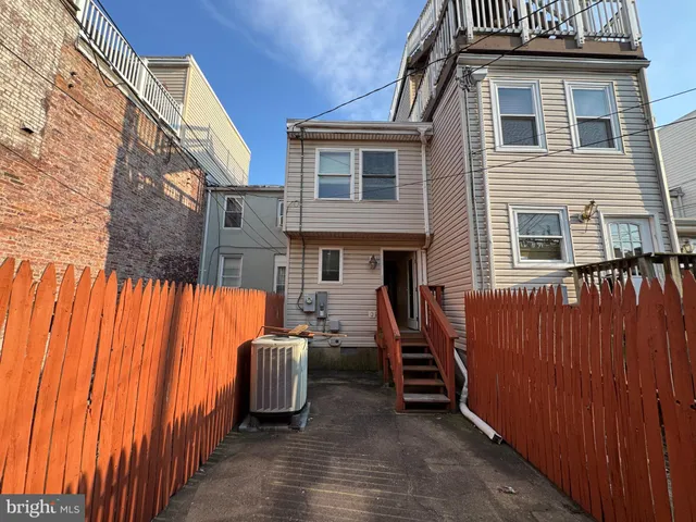 a view of a house with a wooden fence