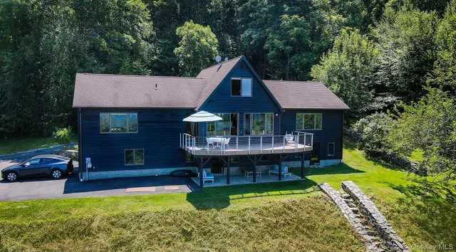 a view of a house with swimming pool and a yard