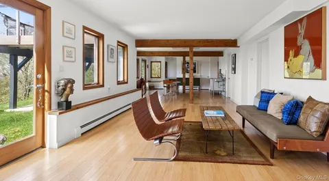 a living room with furniture and large windows