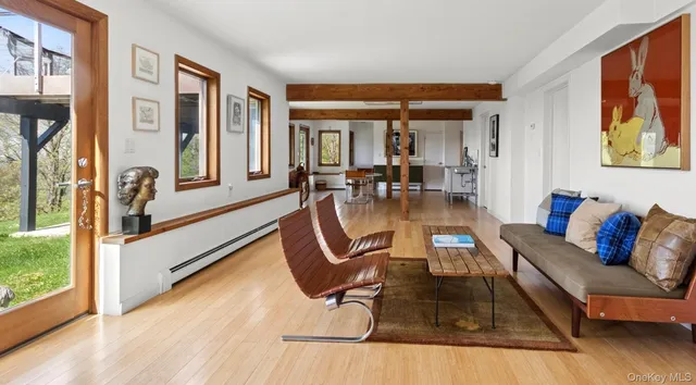 a living room with furniture and large windows