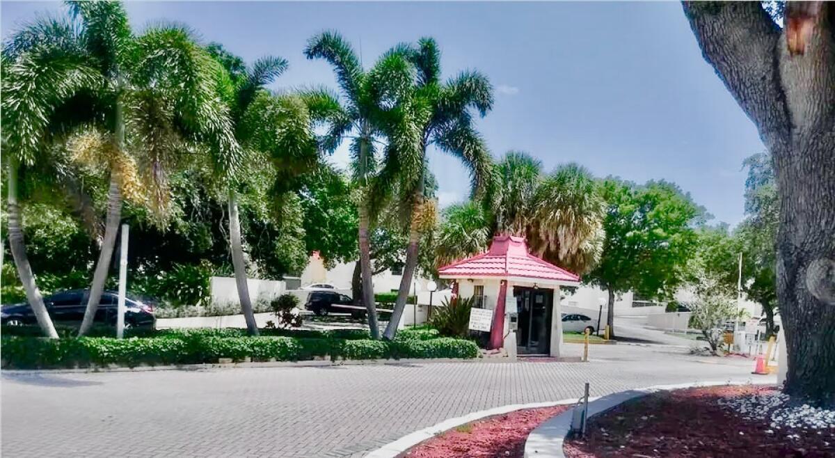 610 Northwest 13th Street, Unit 23 Boca Raton, FL 33486 - Photo 21 of 28 a front view of a house with a yard and trees