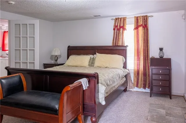 a bedroom with a bed and a couch