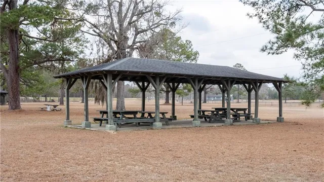 a view of patio with a table and chairs under an umbrella