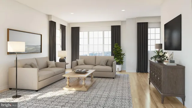 a living room with furniture and a large mirror next to a window