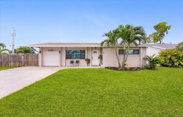 a front view of house with yard and outdoor seating