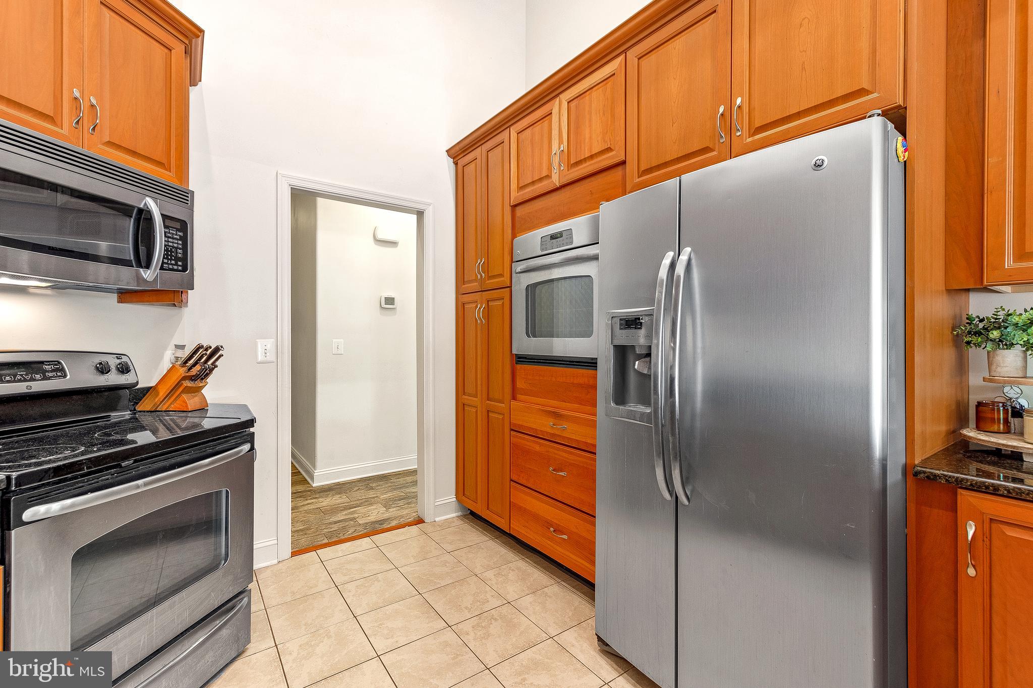 1808 Wilson Road Huntingtown, MD 20639 - Photo 22 of 53 a kitchen with stainless steel appliances granite countertop a refrigerator and a stove
