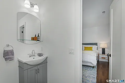a bathroom with a sink a mirror and a toilet