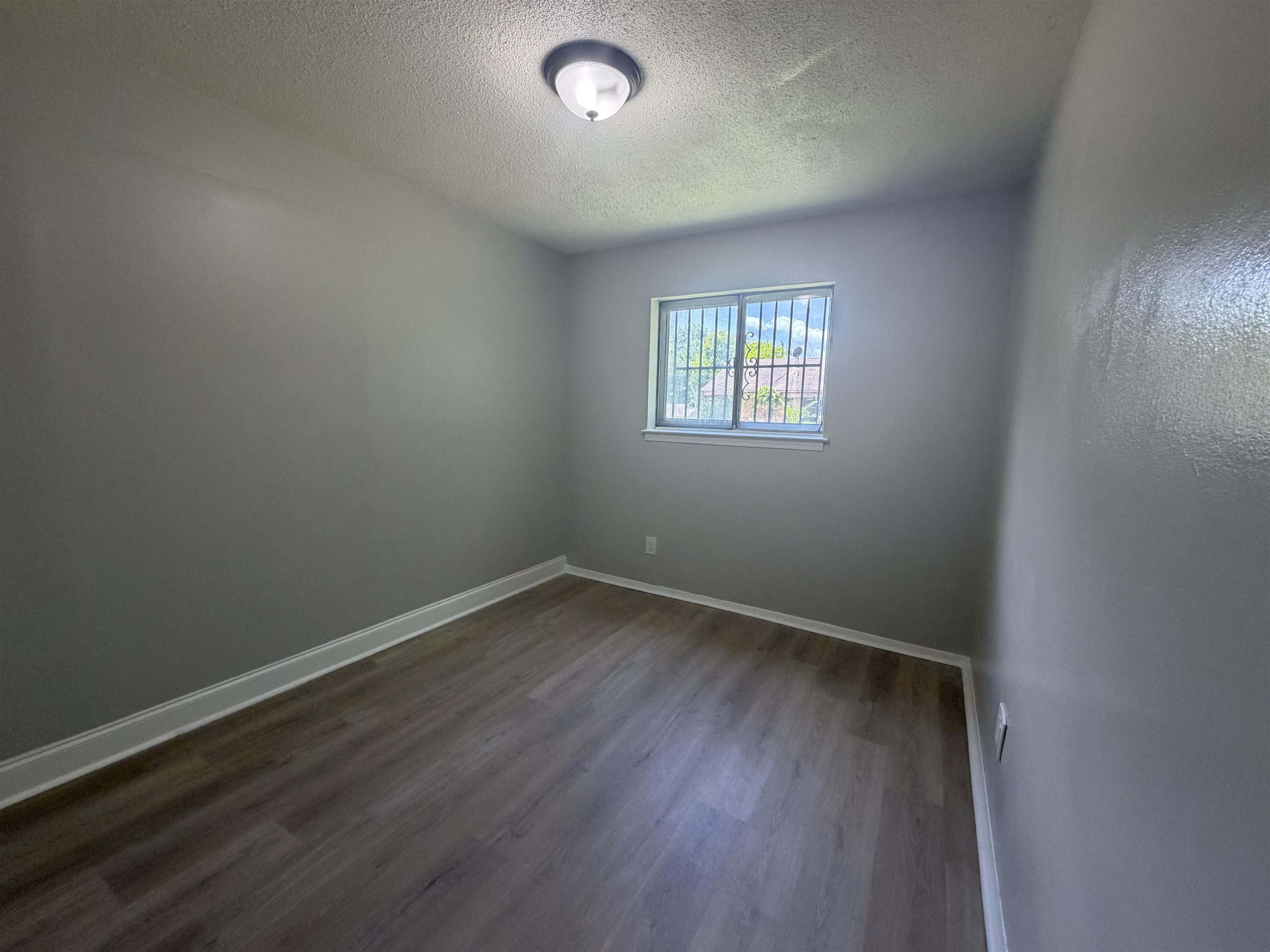 2402 Shasta Avenue Memphis, TN 38108 - Photo 3 of 7 Interior room featuring wood-finish flooring and light gray walls