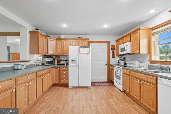 a bedroom with a bed a chair and next to a window