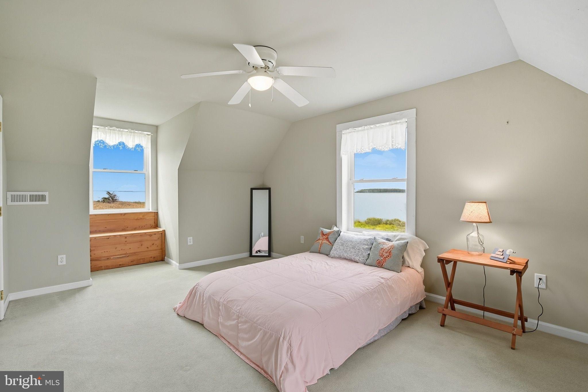 5304 Cassons Neck Road Cambridge, MD 21613 - Photo 22 of 46 a bedroom with a bed and a chandelier