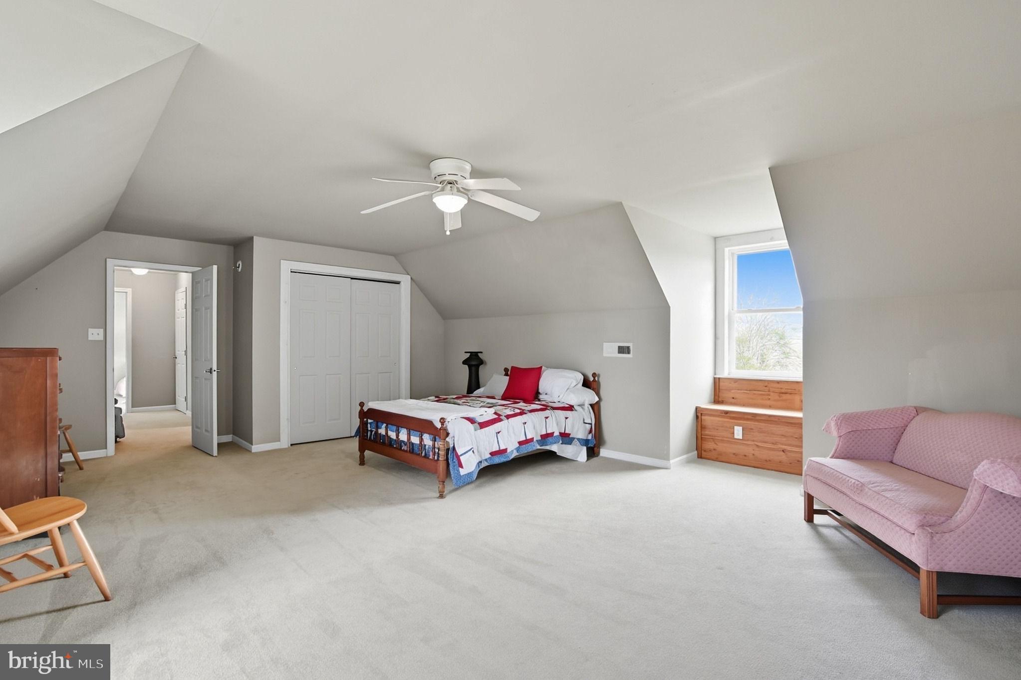 5304 Cassons Neck Road Cambridge, MD 21613 - Photo 24 of 46 a bedroom with furniture and a chandelier