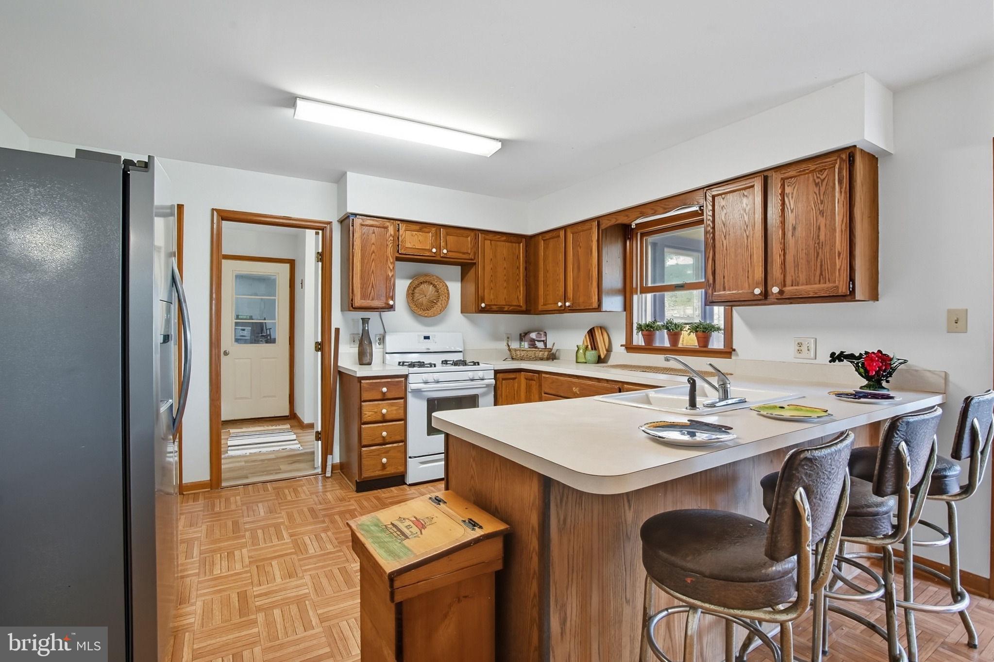 5304 Cassons Neck Road Cambridge, MD 21613 - Photo 35 of 46 a kitchen with a sink stove and refrigerator
